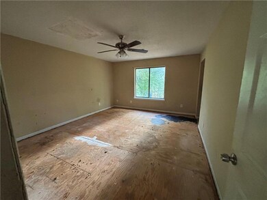 Empty room with baseboards and a ceiling fan