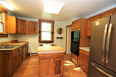 Plenty of Wood Cabinets in 11x10 Kitchen featuring