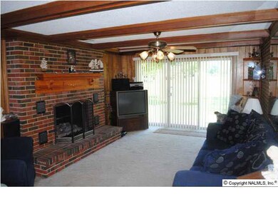 An added family room is a bonus. It has lots of character with the brick wall, brick fireplace and beams. The large window wall adds lots of light.
