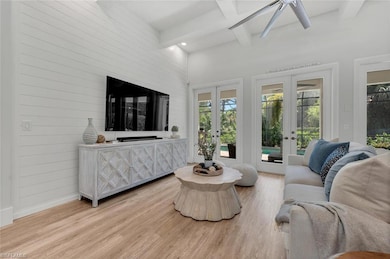 Living room with french doors, coffered ceiling, b
