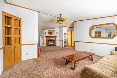 Carpeted living room featuring ornamental molding,