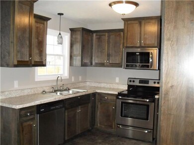 Another view of kitchen with stainless steel appliances.