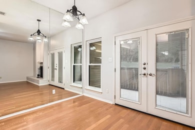 Doorway to outside with an inviting chandelier, f
