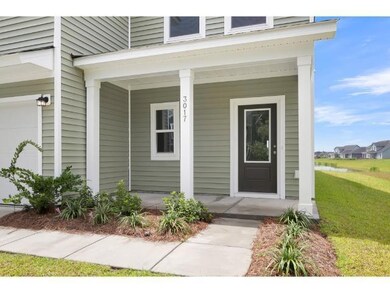 Entrance to property featuring a garage, covered p