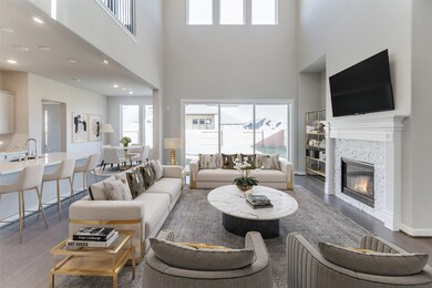 Gather the family and guests together in your lovely living room! Featuring soaring high ceilings, recessed lighting, dark stained ceiling fan, custom paint, gorgeous floors, fireplace with  mantel and large windows that provide plenty of natural lighting throughout the day.
