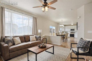 Living area featuring a chandelier, a ceiling fan,