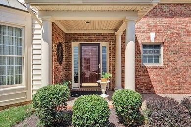 Covered front porch with glass storm door at entra