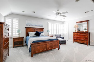 Bedroom featuring ceiling fan, lofted ceiling, and