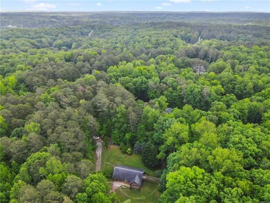 Drone / aerial view with a wooded view