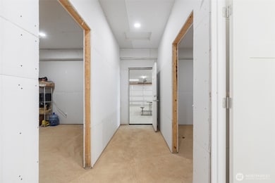 hallway looking at the garage. Two rooms and bathroom to the sides.