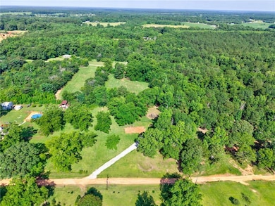 Aerial overview of property's location featuring a forest