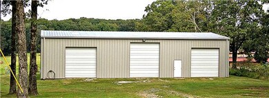 50 x 60 metal insulated shop- 220 power for a welder. Lots of electric outlets. Two (2) 12 foot doors- One (1) 14 foot door and a walk in metal doors in front and  back.