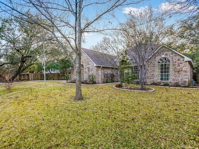 Ranch-style home with brick siding, fence, and a 