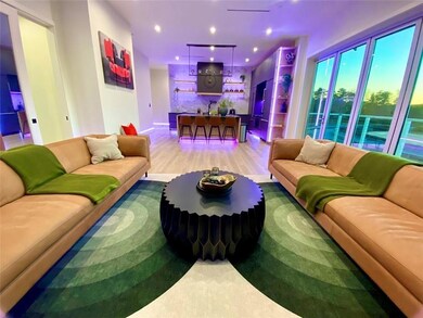Living room with wood-type flooring and indoor bar