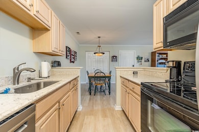 Kitchen featuring crown molding, sink, black appli