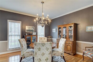 Dining room also has large windows for natural light, as well detailed moldings.