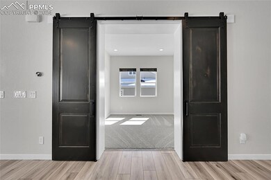 Formal dining room with light carpet and a barn do