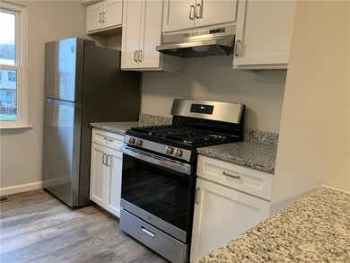 Brand new kitchen with classic white cabinetry, gr
