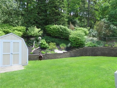 Beautifully tended garden behind versa lock wall.