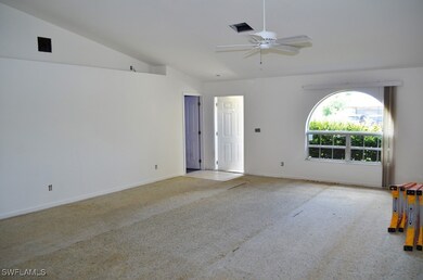 Empty room featuring lofted ceiling, carpet floori