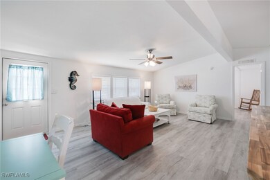 Living room featuring vaulted ceiling with beams,