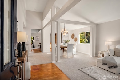 The formal entry opens up to soaring vaulted ceilings and an oak entryway.