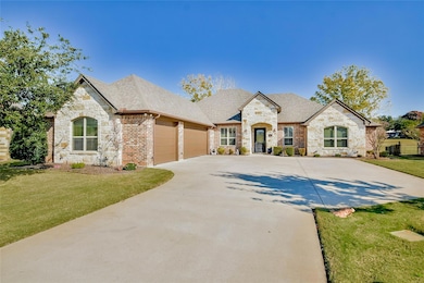 French country style house featuring a front yard and a garage