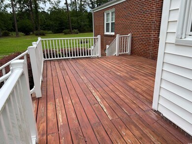 Wooden deck featuring a lawn