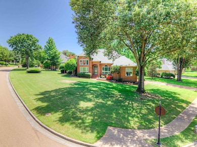 Traditional-style house featuring brick siding and a front yard