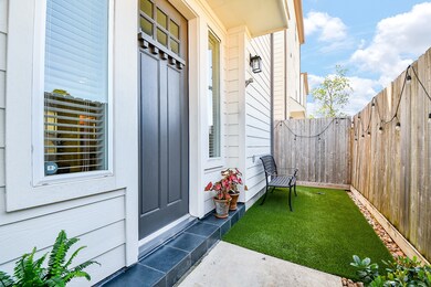 Charming private patio entry with artificial turf