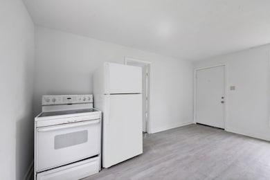This photo showcases a small, minimalist kitchen w
