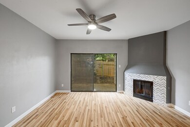 Unfurnished living room featuring a tile fireplac