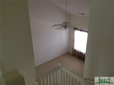 view down into living room from stairs above