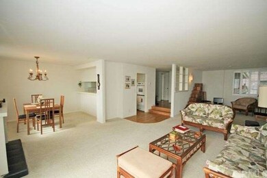 View of dining and living room along with entryway