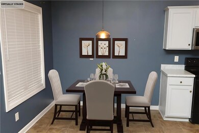 Dining area featuring baseboards and light tile patterned floors