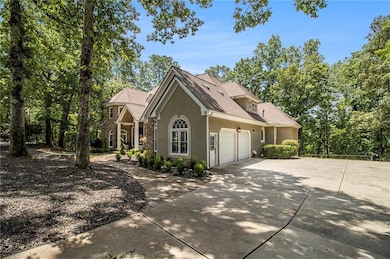 View of front of house featuring stucco siding, a garage, and concrete driveway