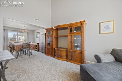 Living room featuring high ceiling and flowing int