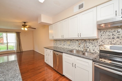 Another view of the kitchen white cabinets and sta