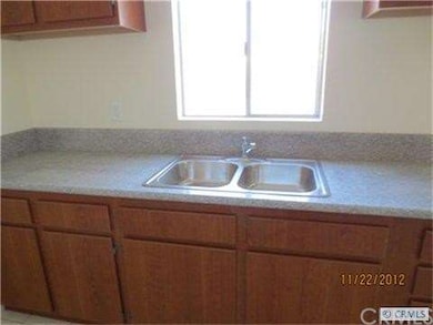 New kitchen with stainless steel sinks and granite counters