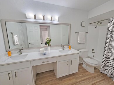 Full bathroom with vanity, hardwood / wood-style f