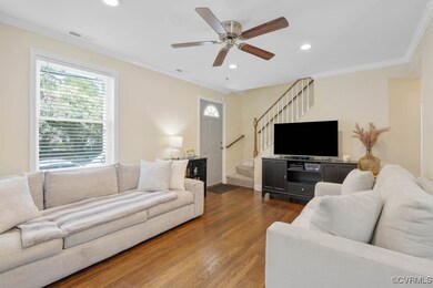Living area featuring stairway, dark wood-type flo