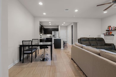 Living area featuring baseboards, visible vents, 