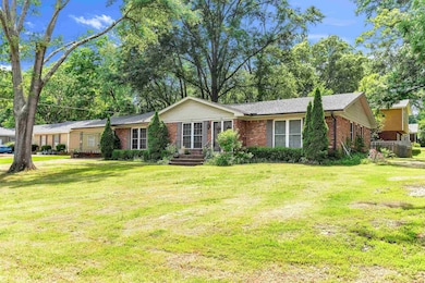 Ranch-style house featuring brick siding and a front yard