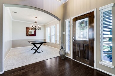 Foyer boasts natural light and hard wood floors.