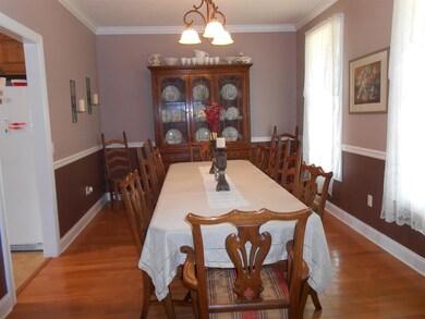Formal Dining Room with Crown Molding, Chair Rail & Hard Wood Floors. Notice the 2  color tones painted on the wall!