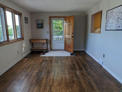 Doorway to outside featuring hardwood / wood-style