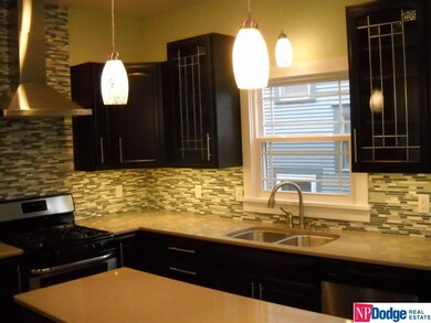 Beautifully updagted kitchen with new paint, windows, cabinets, and solid surface counter top!  Wall cabinets feature under cabinet lighting.