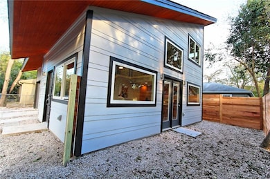 View of property exterior featuring fence