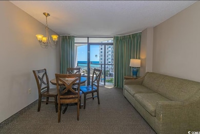 Dining room with a textured ceiling, a water view,