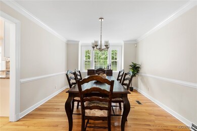 Dining space with a chandelier, light wood-style f